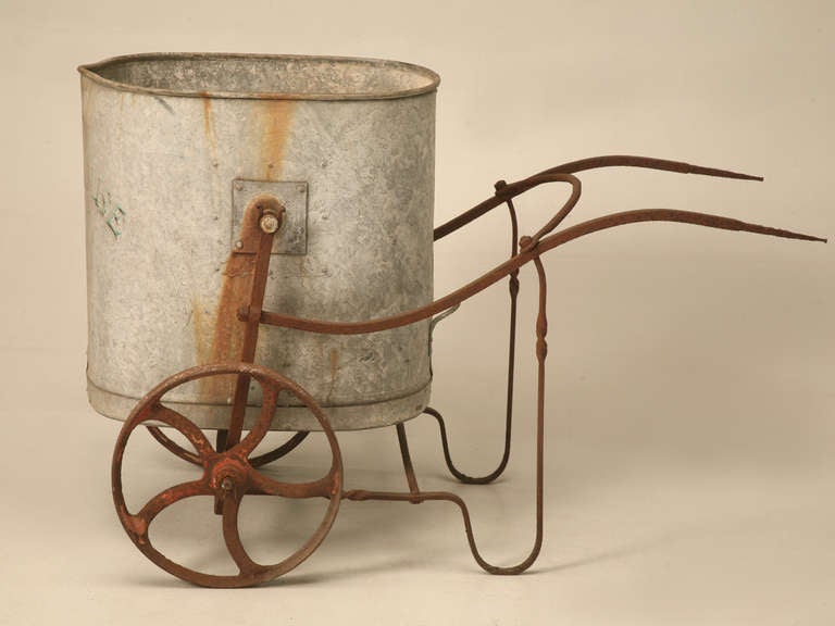 Late 1800's English glass house watering cart. The frame is hand forged steel supported by cast iron wheels. The tub is galvanized steel and hand painted with the words 