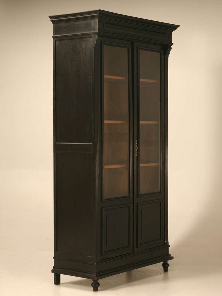 Late 1800's solid ebonized walnut cabinet, that has been thoroughly restored both cosmetically and structurally in our workshop. Unusual petite in scale.