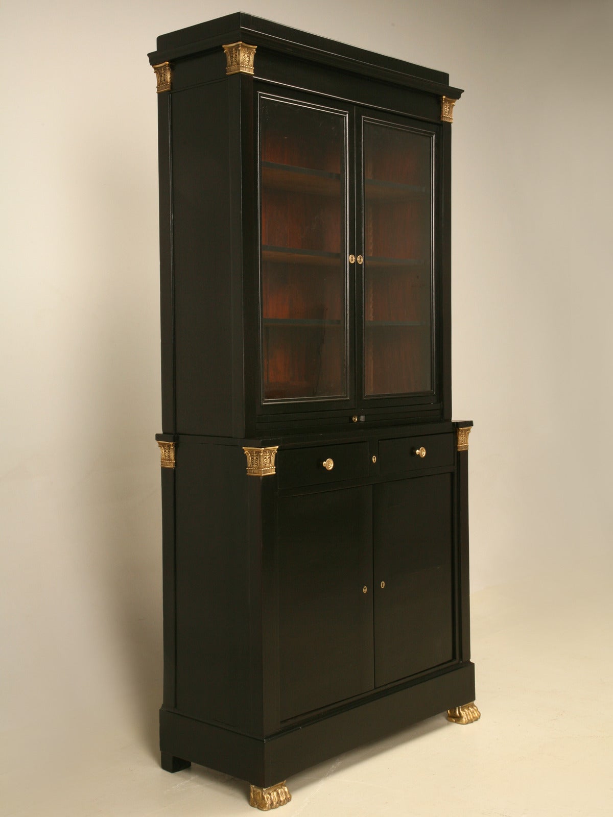 Bookcase or China Cabinet in Ebonized Mahogany and Gilt Paw Feet
