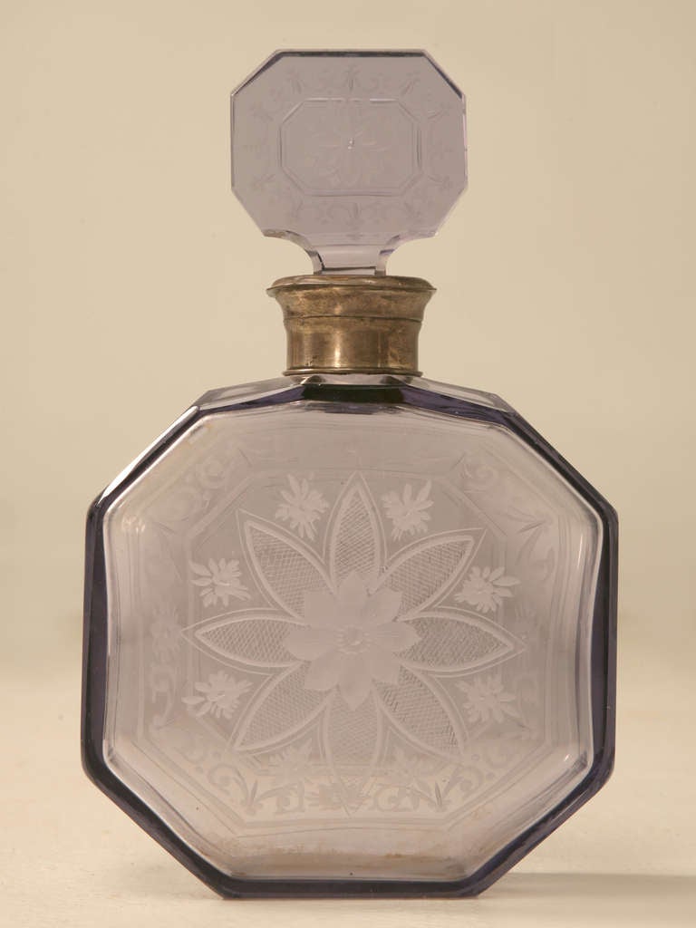 Original antique French decanter with a unique thistle colored glass decorated with delicate etched decorations. Octagonal in shape, this decanter is a bit smaller than the ones for spirits and other libations. A fine silver neck adds a surprise and
