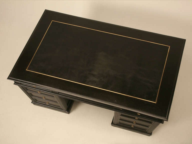 Circa 1860-1880 Authentic ebonized Naopleon III French desk with 12 drawers and 2 doors. The ebonized finish was only touched up as necessary, and remains mostly original. All the drawers have been tended to, so that they function like new, and on