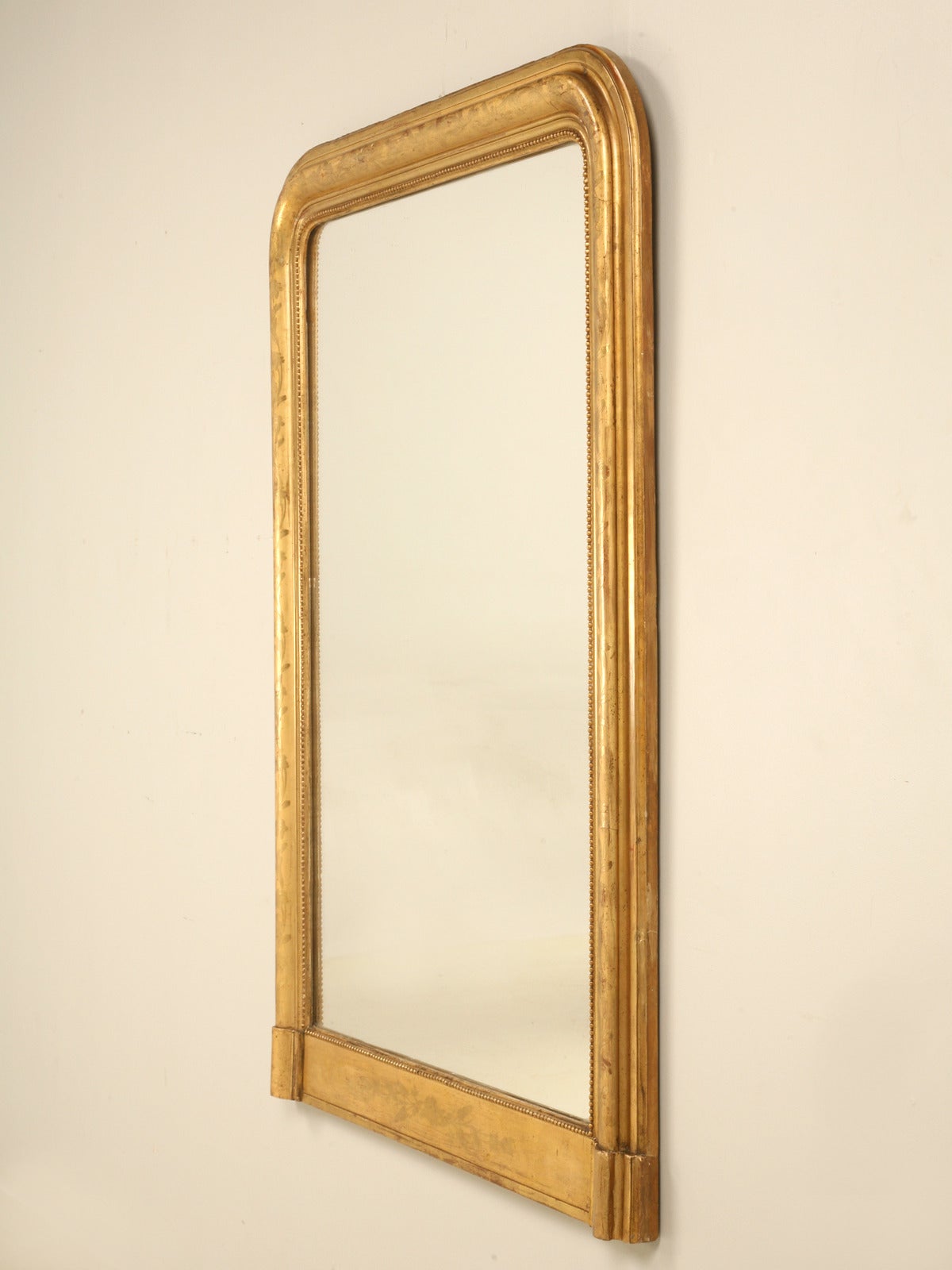 An absolutely all original Louis Philippe style mirror with its original water gilded frame with intricate detailing. Generally we see these frames where someone has used rub and buff, or that old gold radiator paint and ruined any ounce of patina