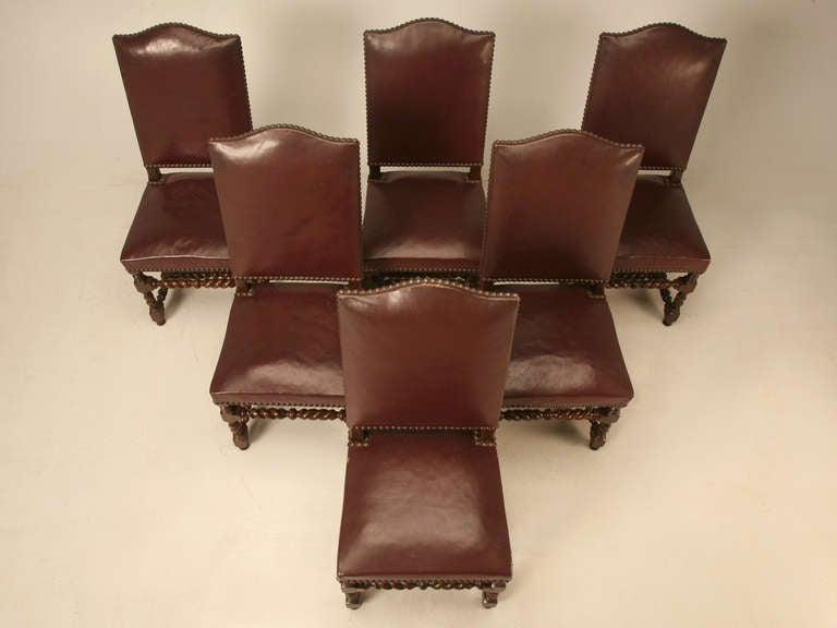 Set of (6) circa 1920's leather covered French barley twist dining chairs. Old fashion wooden peg construction indicates high quality craftsmanship. 

** Seat height is 19