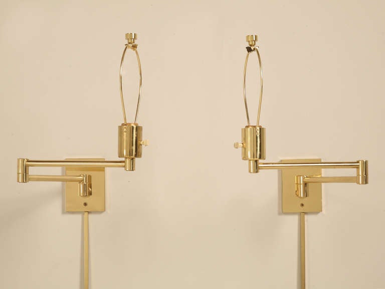 Pair of polished brass swing arm sconces with matching cord covers. Both are stamped Hansen Lamps New York on the top of mounting bracket. Manufactured by Metalarte. Made in Spain

In the seventies, Metalarte launched this famed and much imitated