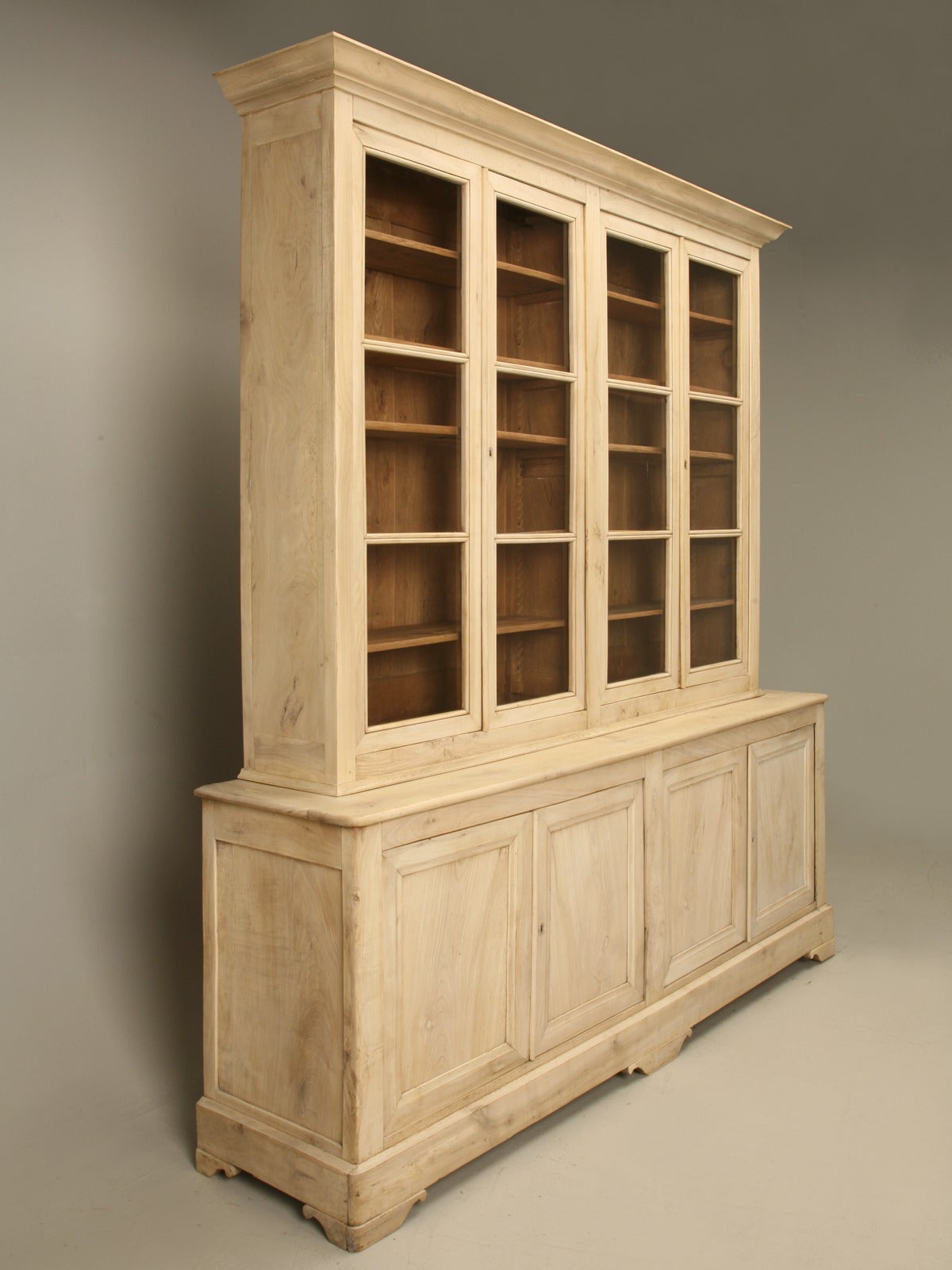 Antique French Walnut bookcase or China cabinet from the late 1800s, that has been thoroughly restored in our Old Plank workshop. They spent over 160 hours of labor completely disassembling and rebuilding the cabinet correctly. The exterior was then