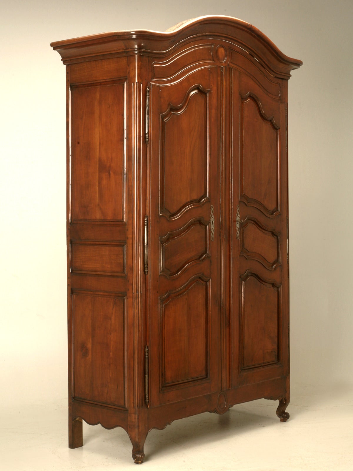 Early 1800's French Solid Cherry Wood Louis XV Style Armoire that has just come out of a laborious 160 man-hour ground up restoration. The complete Antique French Armoire was disassembled down the bare essentials and every joint and connection was