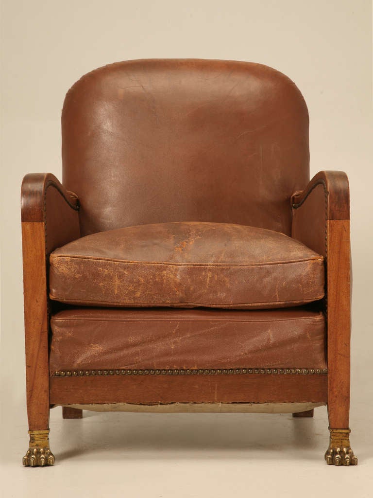 c1940's French leather club chair. In over twenty-five years of searching for authentic all original club chairs, I have never before come across one with lion paw feet. We believe it may have been part of an office suite with a matching desk. The