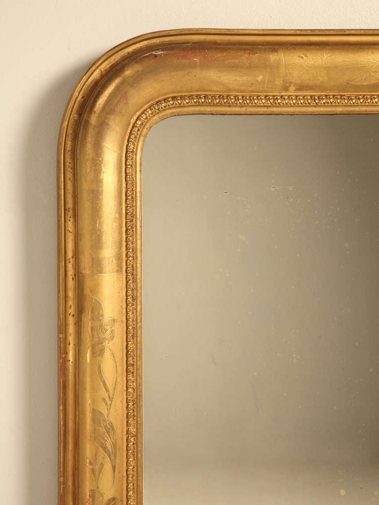 Louis Philippe water gilded mirror in an unusual large-scale, circa 1850. Received minimal restoration. This is original water gilding, not gold radiator paint.