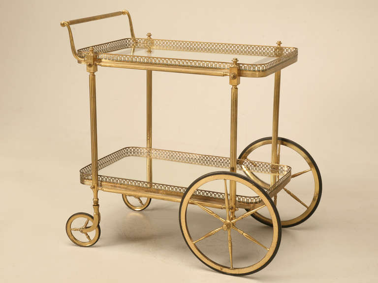 Vintage French tea cart in solid brass, circa 1950s. Generally when we receive these tea carts from France, they are light in weight, and are only brass-plated over steel and pot metal. This one however was manufactured with quality in mind first,