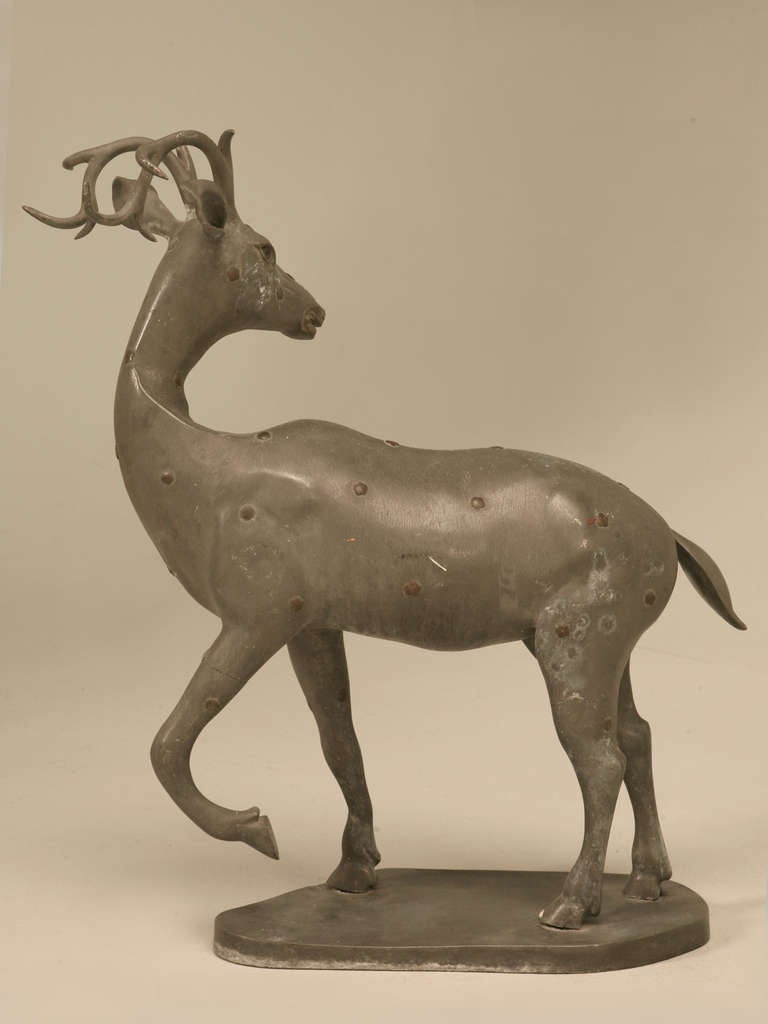 Vintage c1930’s (best guess) French Zinc sculpture of a stag with bronze rosette highlights. Please look carefully for there are several old hairline cracks in the sculpture; however none appear to be structural in nature. Great scale to adorn that