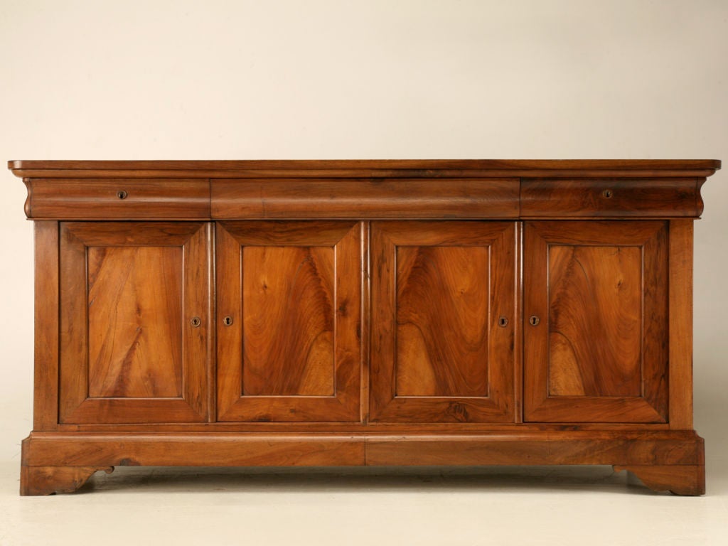 Magnificent original antique French Louis Philippe 3 drawer over 4 door figured walnut buffet. This great buffet is an amazing authentic Louis Philippe period find. The Louis Philippe period (1830-1848) in antique French furniture was derived from