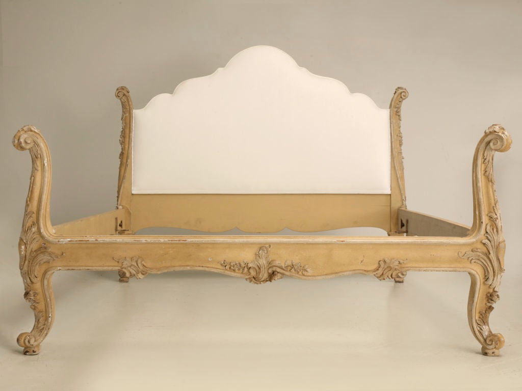 Rare, rare, rare!!! Spectacular vintage French Rococo style heavily carved queen size bed. All the style and charm you could ever want all rolled into this fantastic limed-wood bed. Perfectly suited for any bedroom of the home, the upholstered area