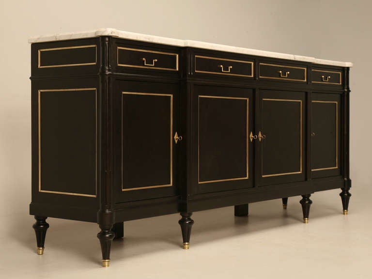 Post WWII Louis XVI STYLE mahogany buffet that we stripped to the bare wood, and carefully hand ebonized with layer upon layer of stains, all the while carefully making sure the natural wood tone still showed through the black. Creating a proper and