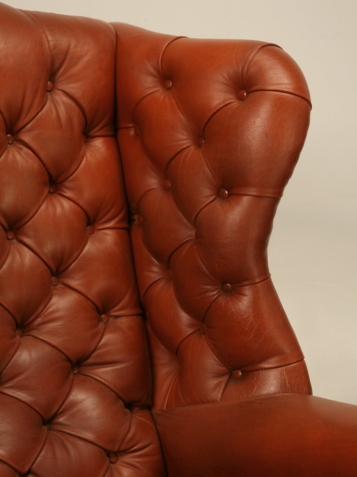 Grand pair of classic English leather Chesterfield wingbacks, from the famous furniture maker; Wade of Great Britain. Wade has long been recognized as one of the finest English manufactures of chairs, with a history dating back to 1921. Their