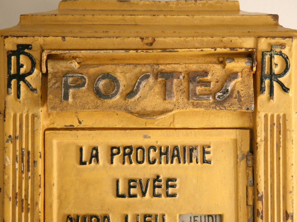 This original, authentic French Art Deco cast iron street corner mailbox would be the ultimate addition to your Country French estate. It is finished with a warm sunny yellow paint and has the word 