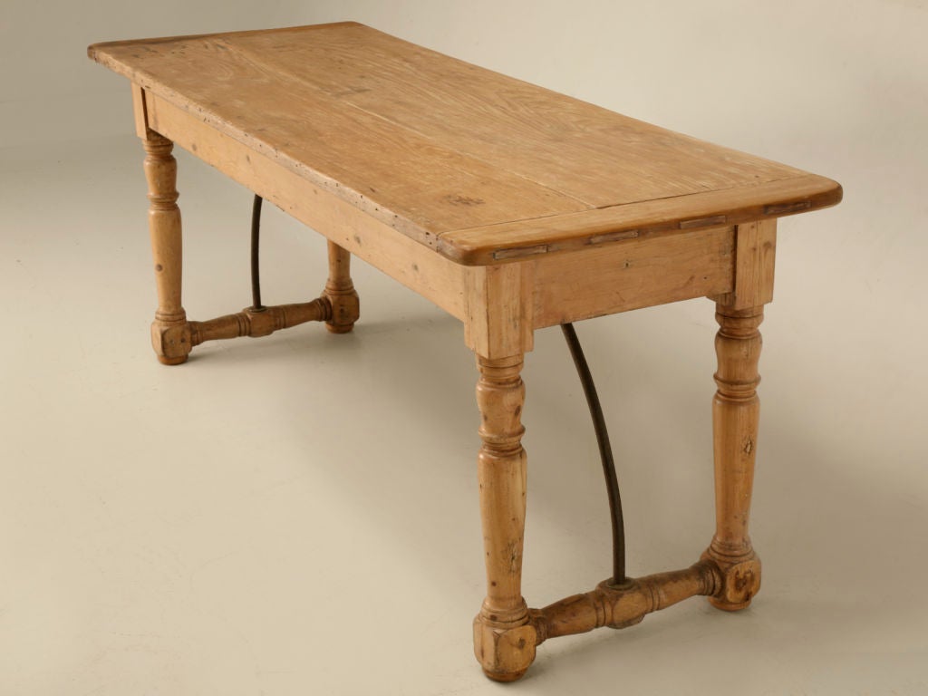 Fantastic original antique Irish work table still retaining it's hand-wrought iron braces for added strength and stability. Originally utilized in farm house kitchens, tables such as this were highly prized and well used very utilitarian pieces.