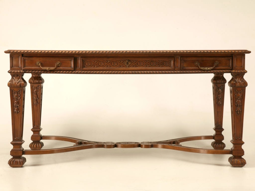 Extraordinary antique French Louis XIV style table with 3 hand-dovetailed drawers, and 4 square carved baluster legs connected by a carved curule shaped stretcher. This dynamite table finished on all sides would be awesome many places, in the