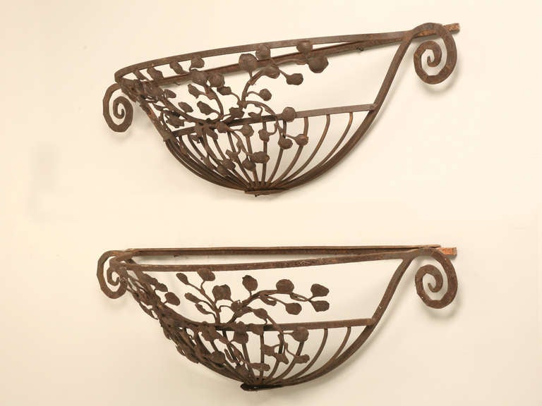Stellar pair of original hand wrought antique French iron window box planters. These are incredible with their individual leaves flowing gracefully while encapsulating your plantings. Large in size, these were probably commissioned to grace a large