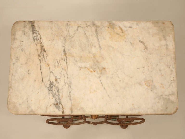 French butcher presentation table, circa 1880-1910. This may be the most copied and reproduced French item in history, but when you see an original and completely untouched table there is no comparison. The patination of the marble speaks as loud