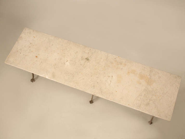 Circa 1900-1920 French Cast Iron and Marble Bistro Table, or as they would call it across the pond; le grande table metal. Either way, what makes it so nice is the size, and it can be used indoors or outdoors. The metal base has layers of old