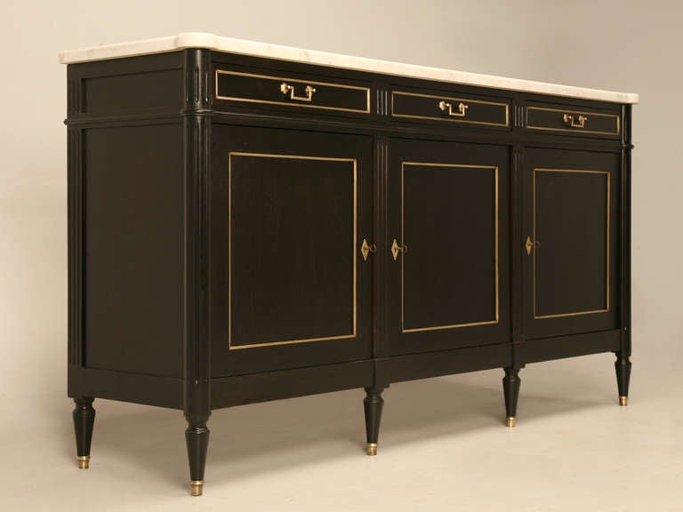 French ebonized mahogany Louis Philippe style buffet, circa 1930s. Kind of unusual, because whoever made the cabinet went to great pains to construct the drawers like a period piece would be. Take a look at the large dovetails, and the nice solid