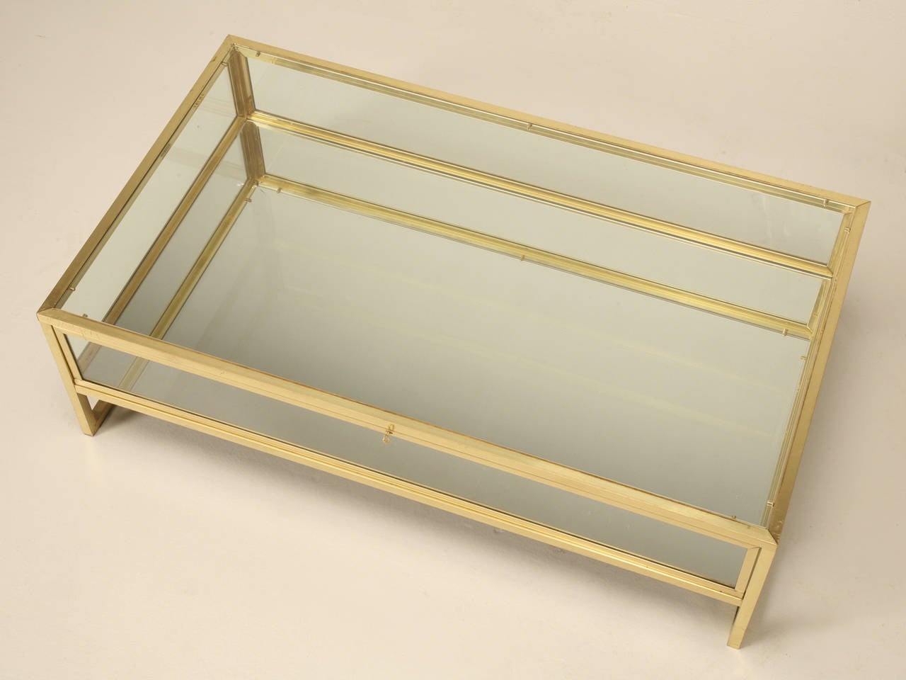 Very unusual, French Mid-Century Modern brass and glass coffee table, that doubles as a display case for your special collections. Could be a lot of fun changing it out for the holidays, or for a special birthday, where one might display photographs