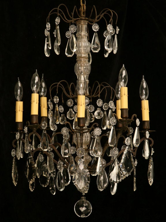 Exquisite restored French 1920's 8 light Crystal Chandelier with a Bronze frame and many polished hand-cut crystal prisms. A definite show-stopper this is a true eye catcher with its crystal spire, and charm with its outstanding display of refracted