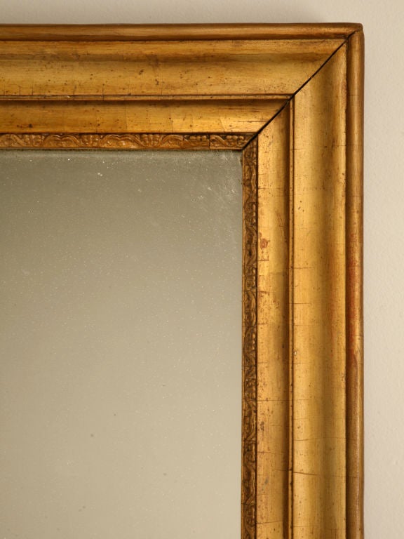 Fantastic original antique French mirror in its remarkable original gilt frame. Use this fine mirror that is just beginning to sugar, horizontally or vertically, whichever suits you needs best. Awesome over a buffet in the dining room, the sofa in