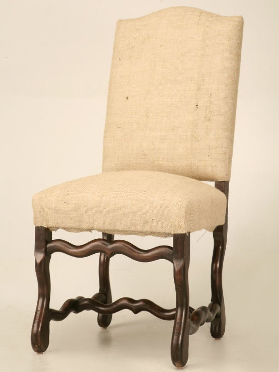 Spectacular set of four classic antique French solid oak Louis XIII or Os De Mouton dining chairs. This set has been fully restored structurally, having tight strong frames, and a new upholstery base including new springs, paddings, and burlap.