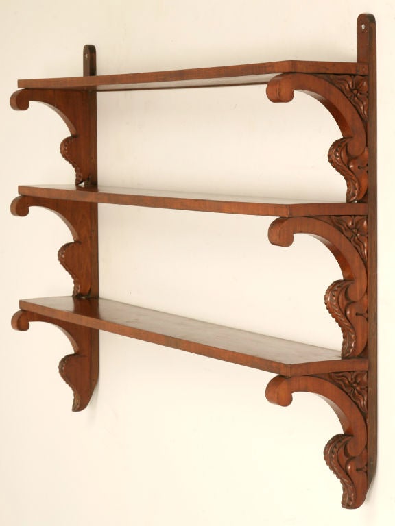 Breathtaking antique English mahogany wall shelves with beautifully carved bracketed supports. Perfect many places, this striking well made shelf would be awesome in any room of the home. Storing and displaying toiletries in the master bath, a