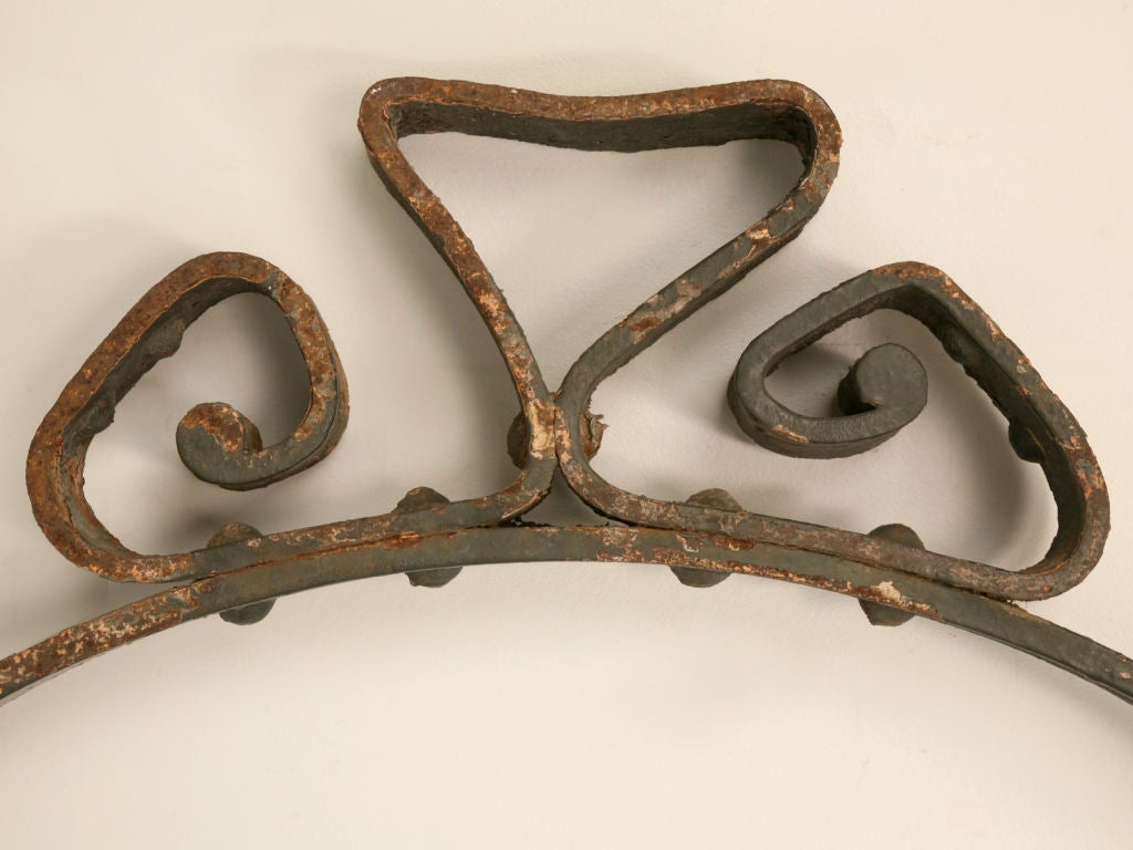 Stunning handwrought iron antique French sign frame retaining bits of it's original paint. Though we aren't sure what type of business this was used for, we thought it would be great in a loft apartment as a very hip mirror or clock frame. Or you