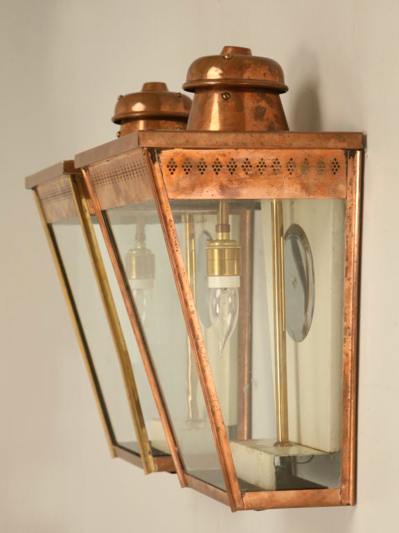 Magnificent pair of fully restored antique English copper coach or wall lanterns. These are wonderful with only slight tarnishing, you want them polished and lacquered or let them age and weather naturally to a great verde appearance. Whatever you