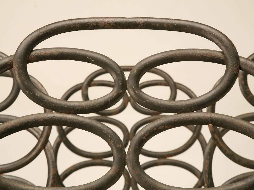 Spectacular set of 6 original vintage forged iron garden chairs (1 armchair & 5 sides) with an intricate loop or pretzel back, a lattice seat and curved legs, too--a distinct look to say the least. <br />
<br />
Provenance: From a home on Green