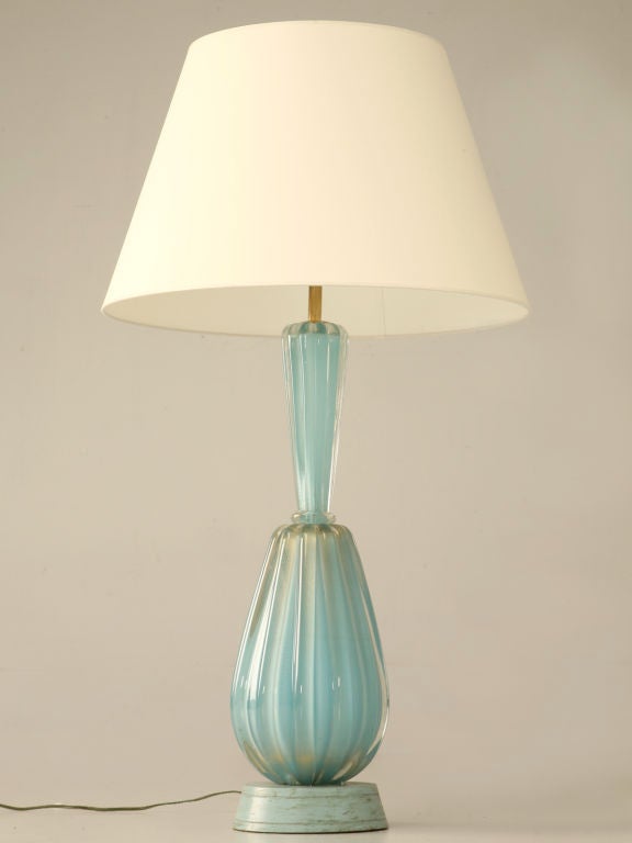 Stunning vintage Italian Murano venetian glass table torchiere. Absolutely awesome, the color is amazing, a soft Opaline blue highlighted with a glittery golden shimmer. A great lamp with loads of possibilities.<br />
<br />
** Height (1) includes