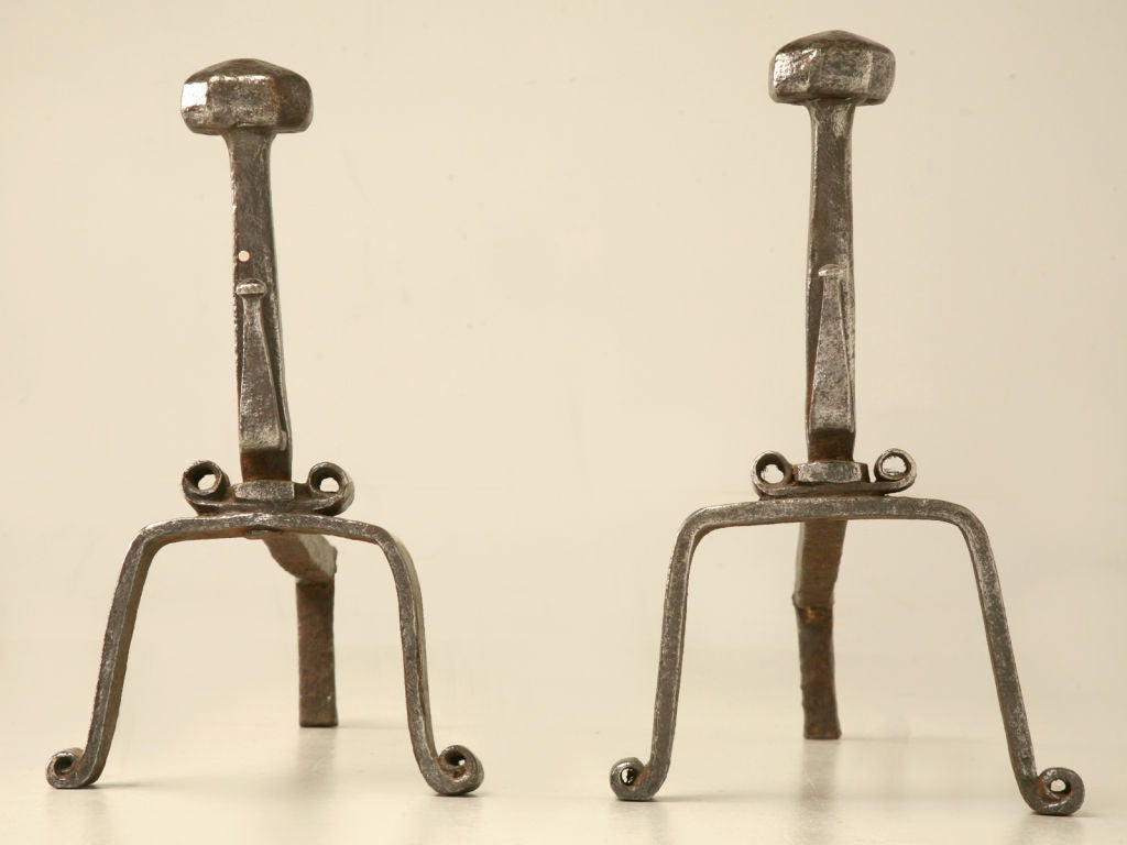 Unique and stylish, this pair of English Arts & Crafts andirons is fantastic.<br />
<br />
** Please note sizes are different. The measurements below are for the larger andiron. The smaller one is 15.75