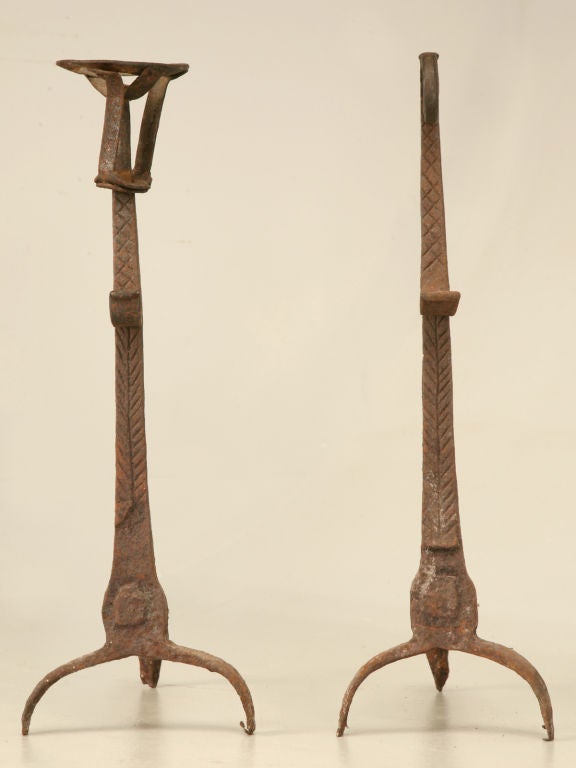 Outstanding pair of authentic eighteenth century French Hand-Wrought Iron Andirons. Though these are well used, there is loads of life left in them. Very well executed considering their age. Judging by the way they were constructed, we're guessing