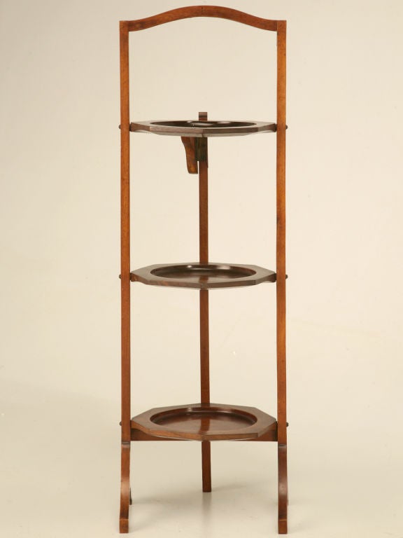 Awesome vintage English flat-folding cake or muffin stand. Very practical with many uses, this great stand may be used either on the table or floor. Magazines, toiletries, or knick-knacks would look fantastic on this fine stand.