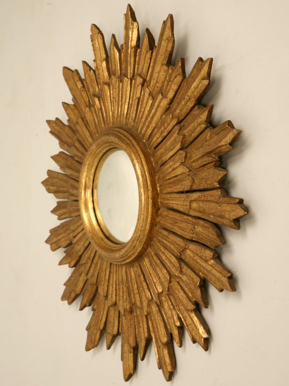 Stunning vintage Italian carved and gilded sunburst form convex mirror. Make a statement, our in-house designer usually showcases sunburst mirrors in groupings of five or more. They are also fine alone as an interesting accent. Whatever you choose,