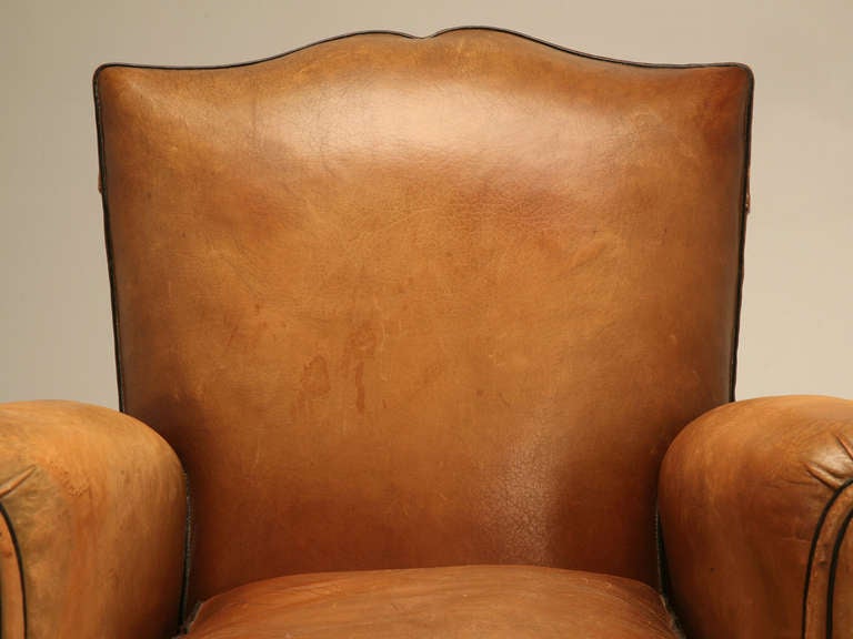 Ooh-la-la! As they say in France when they find something that is the creme de la creme. It is what our buyer said when we found this exquisite pair of original French forties leather club chairs with extremely desirable moustache shaped backs. If