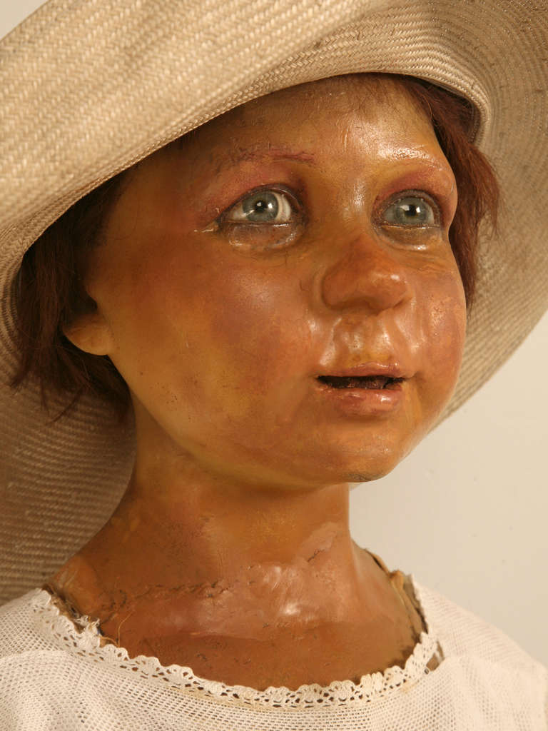 Circa 1880-1900 French Mannequin. The entire head and neck are made from a hard wax, the eyes are glass, and the hair is human to the best we can determine. When we were trying to determine her age, we went under the assumption that the shoes are