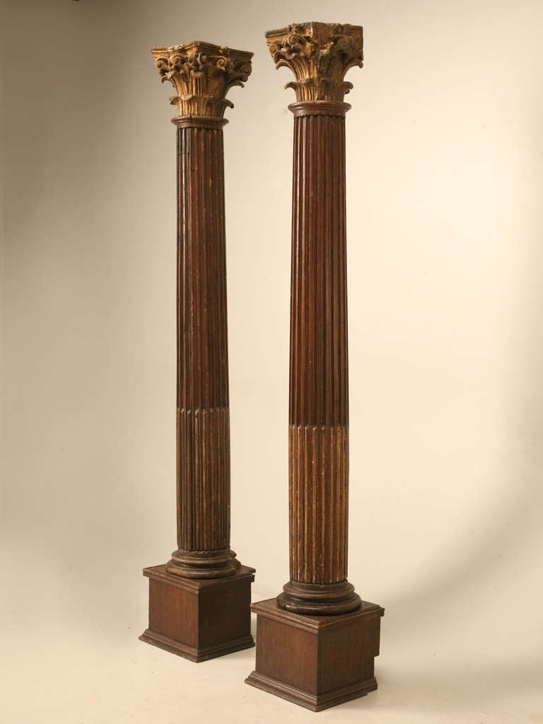 Circa 1800-1820 French White Oak beautifully hand-carved corinthian columns in their original finish with gilded capitals. We purposely left the columns in as found condition, and can restore them to any level you would like. They can also be