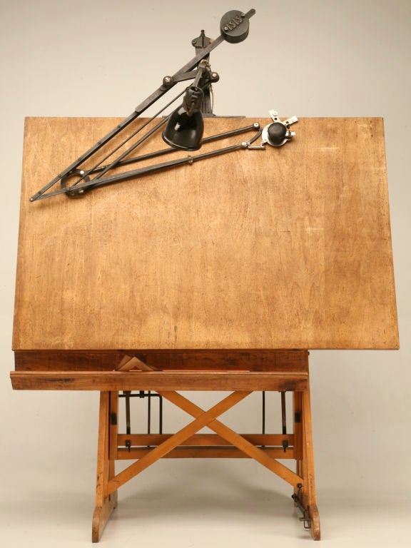 Professional architect's drafting table on stand with it's original articulated lamp. The stand is 'counter weighted' (with springs) to make height adjustment of table easily managed. Table can be locked at any angle from vertical to horizontal.
