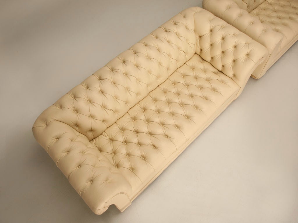 Stunning pair of vintage chesterfield style sofas upholstered in a sumptuous cream colored leather upholstery. Classic proportions, and comfortable seating make chesterfield sofas a perfect choice amongst design professionals. Use this fine pair