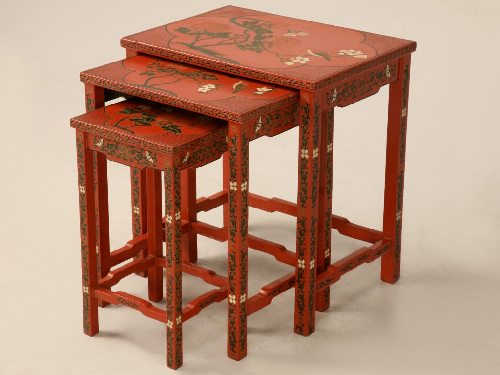 Wonderful set of 3 Chinese red lacquered nesting tables. Perfect for small spaces, as the set of three actually only take up the footprint of one. A must for entertaining, these would work well in most any room of the house, then when needed they