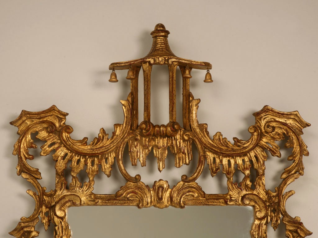 Phenomenal vintage Italian carved and gilded Chinese Chippendale style mirror. Having a pagoda relief, intricate carved details, and a distinctive gold finish are all notable characteristics of this exquisite mirror. <br />
<br />
English