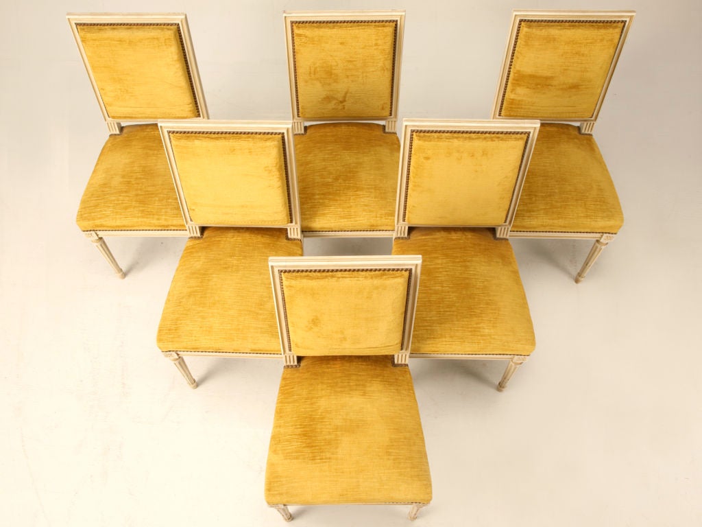 Stunning set of 6 vintage painted Louis XVI dining side chairs. This set is special, having clean uncluttered lines and carved flower-form rosettes at the corners, making them well-suited to mate with any style decor from very traditional to ultra