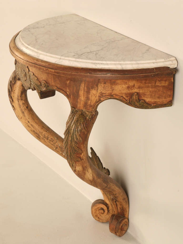 Petite 18th century Norwegian Rococo style console with it's original marble top. Expertly constructed of solid  elm this exquisite table retains traces of original paint. It's rounded demi- lune form makes it a perfect fit for so many places.
