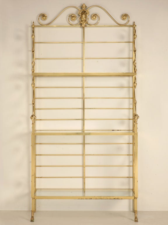 Not your run of the mill baker's rack here, this beauty has all the bells and whistles you could ever want. Stylish details include scrolled shelf supports with rosettes, a full back ladder for hanging pot lids and utensils, and 3 glass shelves to