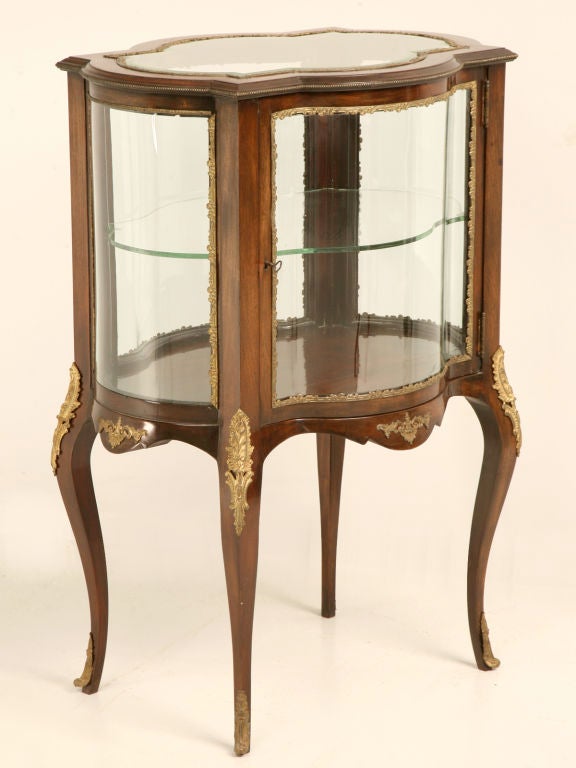This fine Vernis Martin Louis XV style clover shaped vitrine would be awesome so many places. Perfect as a nightstand, end table or even a gueridon, this beauty is finished on all four sides allowing it to easily float within the room. A great