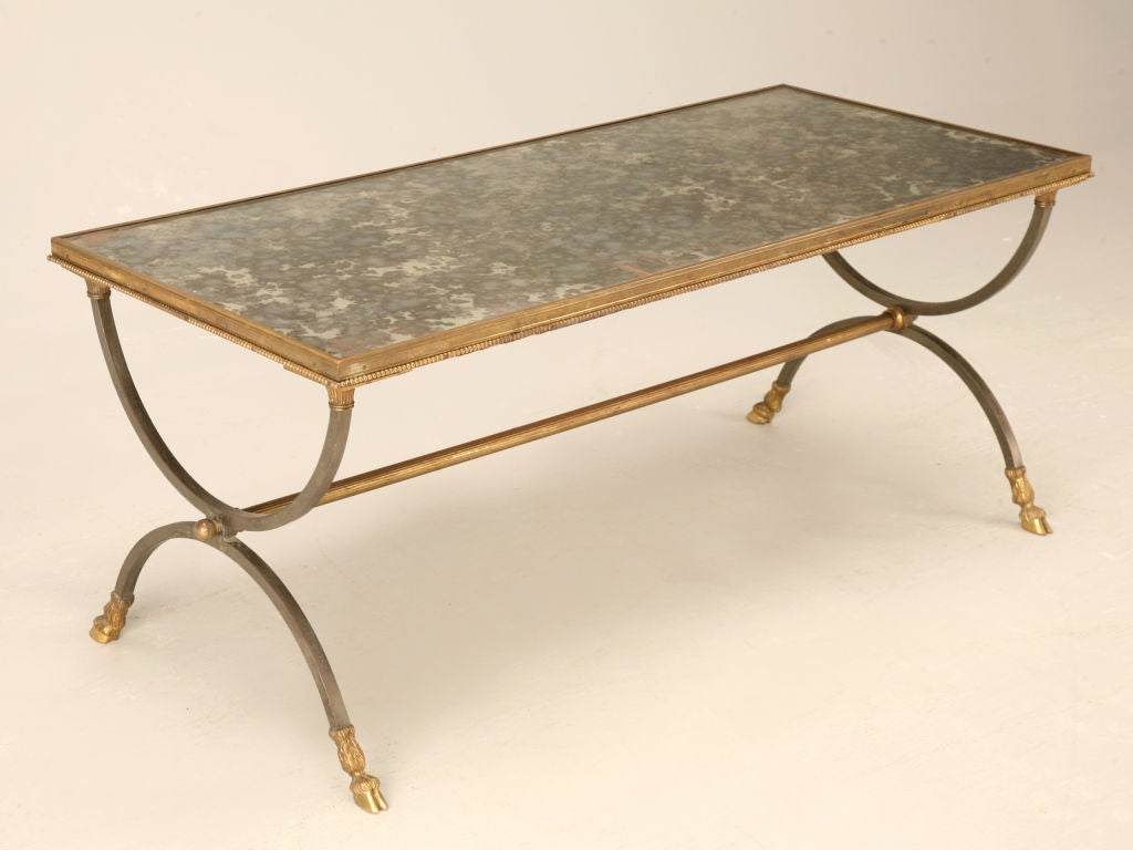 WOW! What a statement, this extraordinary vintage French Maison Jansen mirrored top coffee table makes. Paying special attention to details such as curule shaped legs, a distinctive beaded edge and hairy hoof shaped feet make this Jansen table stand